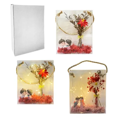 FLORES ARTIFICIALES CON NOVIOS Y LUZ EN CAJA CRISTAL